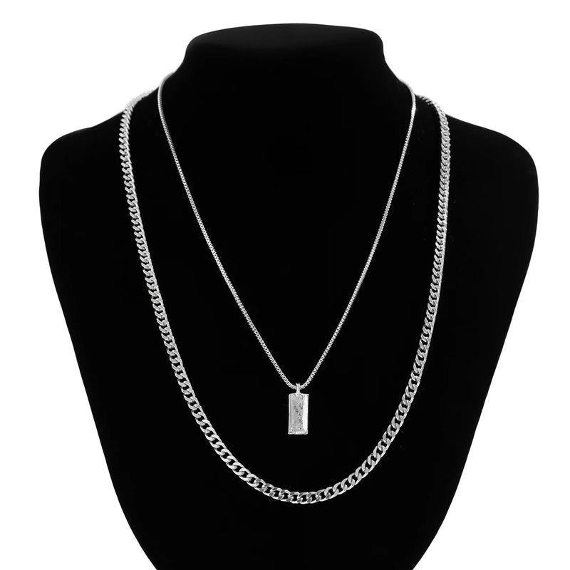 KunJoe – Conjunto de 2 Colares Masculinos Estilo Punk | Corrente Cubana + Choker com Elos Retangulares
Complete o seu visual com este conjunto exclusivo de 2 colares em prata metálica. Composto por uma corrente cubana robu