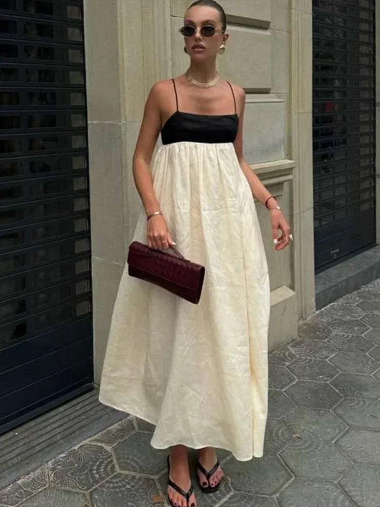 Vestidos longos de linho feminino com alças, em estilo patchwork preto e branco. Com detalhes plissados e corte solto, oferecem conforto e elegância. O contraste de cores confere um toque moderno e sofisticado, perfeito par