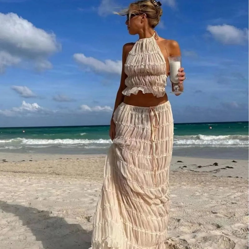 Conjunto Feminino Verão 2024 – Elegância & Estilo em 2 Peças
Descubra o charme do verão com este conjunto feminino exclusivo, composto por uma saia longa maxi plissada e um top com decote halter e costas nuas, realçado