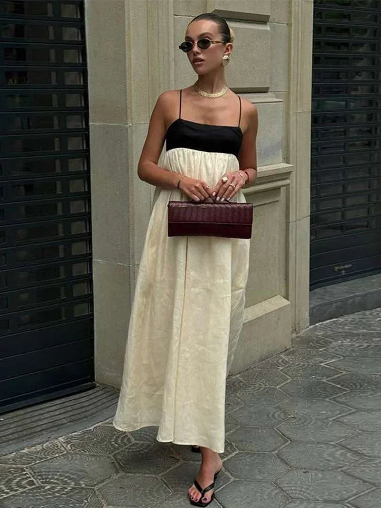 Vestidos longos de linho feminino com alças, em estilo patchwork preto e branco. Com detalhes plissados e corte solto, oferecem conforto e elegância. O contraste de cores confere um toque moderno e sofisticado, perfeito par