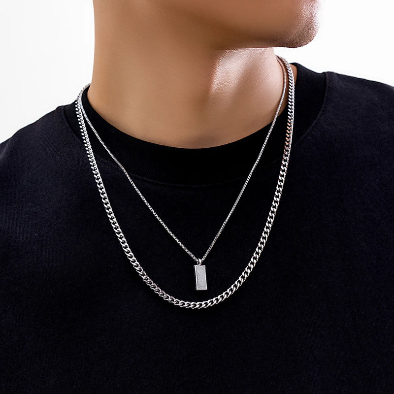 KunJoe – Conjunto de 2 Colares Masculinos Estilo Punk | Corrente Cubana + Choker com Elos Retangulares
Complete o seu visual com este conjunto exclusivo de 2 colares em prata metálica. Composto por uma corrente cubana robu